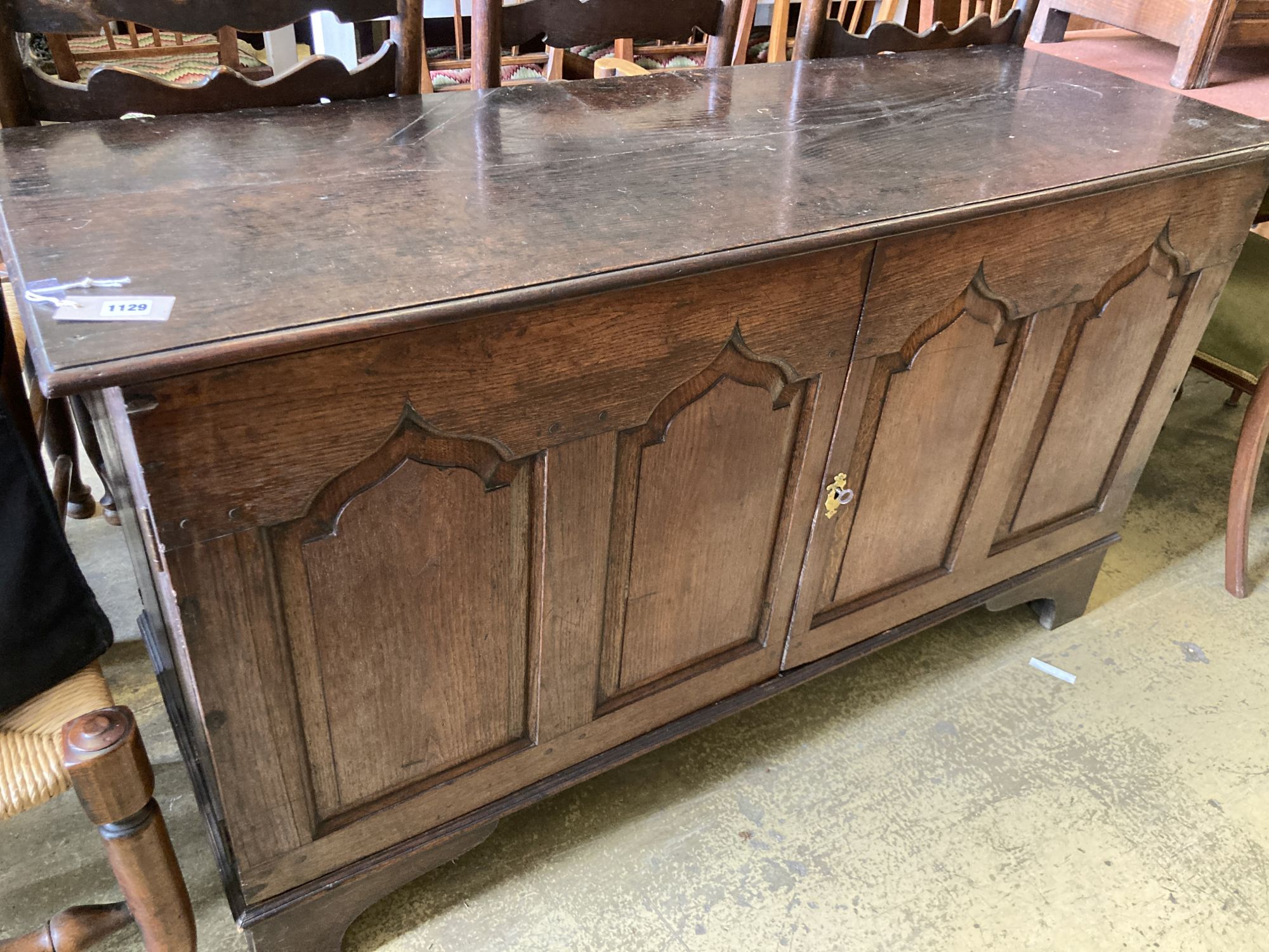 A mid 18th century oak two door cupboard, (converted from a coffer), width 144cm, depth 50cm, height 80cm